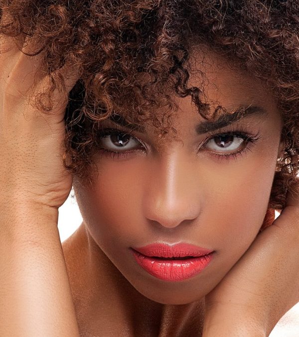 Stunning beautiful young african american black woman. Beauty portrait. Afro hairstyle. Glamour makeup. White background. Studio shot.