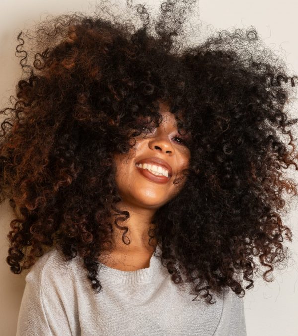 Beauty portrait of african american woman with afro hairstyle and glamour makeup. Brazilian woman. Mixed race. Curly hair. Hair style. White background.